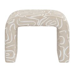 the foot stool is made out of fabric and has an intricate pattern on it,