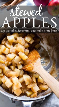 an apple frying in a pan with wooden spoons and apples on the side