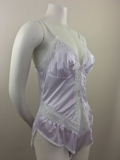 "Vintage 1980's lavender teddie has lace accents on the straps, chest/bodice, and hips; lace-up front closure; and crotch snap (3) closure. Made in USA The condition of this item = Excellent BRAND: Vassarette a Division of Munsingwear, Inc. SIZE: 36 Medium Note: Vintage items are typically sized differently from modern sizes; please review the Measurements section below to ensure an accurate fit. MEASUREMENTS Bust, waist, and hip measurements have been doubled. Shoulder (shoulder seam to shoulde Purple Lace Fitted Sleepwear, Fitted Purple Lace Sleepwear, Purple Lace Sleepwear With Lace Trim, Lavender Fitted Sleeveless Sleepwear, Purple Fitted Sleepwear With Spaghetti Straps, Fitted Lavender Sleeveless Sleepwear, Fitted Purple Coquette Sleepwear, Fitted Sleeveless Purple Sleepwear, Fitted Feminine Purple Sleepwear