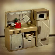 a cardboard toy kitchen is shown on the floor