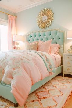 a bedroom decorated in pastel colors and gold accents