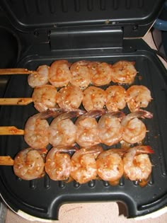 there are many shrimp skewers on the grill