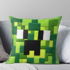 a green and black pillow with a dog on it's face in the center