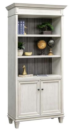 a white bookcase with two doors and shelves