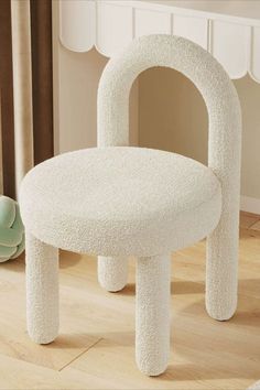 a white chair sitting on top of a hard wood floor