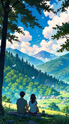 two people sitting on a bench looking out at the mountains and trees in front of them