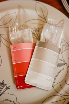 two samples of paint sitting on top of a white plate with red and orange accents