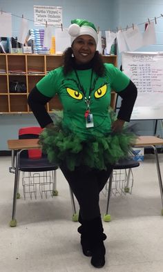 a woman dressed in green and black posing for the camera