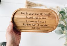 a person holding up a wooden plaque that says,'enjoy your pocket daddy i can't wait to play you caring home is the best part of my day