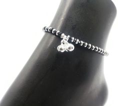 "Description 925 Sterling Silver Stretchable Black Bead Anklet (92.5% Silver purity) available in four to five lengths from from 4.5 inch (0-12 month) ,5.5 inch (1-3 Years) 6.5 inch (4-9 Years) & 7.5 inch (10-12 Years)and suitable for daily use. Makes low bell / charms sound \"chann-chann-chann\", weaved with NYLON Flexible elastic WIRES and stretchable . SOLD IN PAIRS. Dimensions Anklet Weight: ~11.0-16.0 grams / pair. 1 Pair 4.5-inch + 0.5 inch (nylon stretchable Extension) Anklet: ~11.0-1 Cheap Adjustable Black Beaded Anklets, Affordable Adjustable Black Beaded Anklets, Bead Anklet, Bell Sound, Beautiful Anklet, Beaded Anklets, Nose Stud, Tiffany Heart, Heart Charm Bracelet