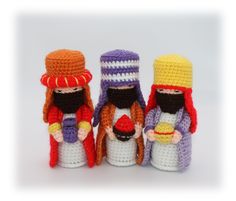 three crocheted figurines are standing next to each other on a white surface