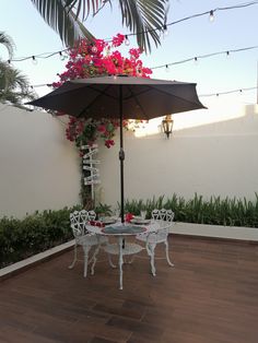 an umbrella and table with flowers on it