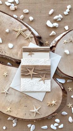 two cards with gold stars on them are sitting on wood slices and scattered confetti