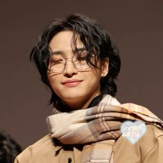 a man with glasses and a scarf around his neck