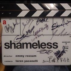 someone holding up a sign with the words shameless on it