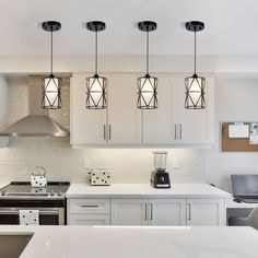 a modern kitchen with white cabinets and stainless steel appliances, including an island countertop