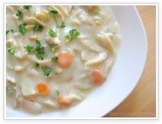 a white bowl filled with chicken noodle soup