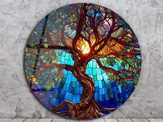 a round stained glass window with a tree on it