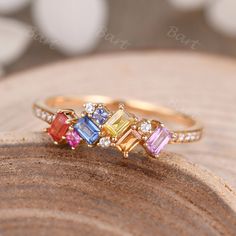 A colorful array of multi-shape colorful natural sapphires brings an edgy elegance to this rainbow statement ring with diamond accents. The glamorous stones glimmer in the light revealing a rainbow of colors. It would be a great Christmas Gift, Mother's Gift, Daughter's Birthday Gift, or Even Lesbian Jewelry. ◆ Product Specifications ※18K Yellow gold ※Rainbow Color Natural Sapphire,2x3mm Baguette Cut, Princess Cut ※Natural Diamond,0.1ct Round Cut, VS1 Clarity, G-H Color ※Setting: Prong,Bar Setti Multi Color Stone Ring, Multicolor Sapphire Ring With Diamonds As Gift, Lesbian Ring, Rainbow Wedding Band, Birthstones Jewelry, Mom Rings, Colorful Rings, Rainbow Bar, Sapphire And Diamond Band