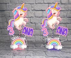 there are two unicorns standing on top of each other in front of a brick wall