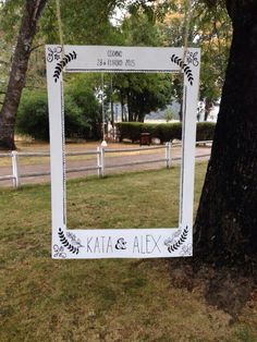 a white mirror sitting on the side of a tree in front of a street sign