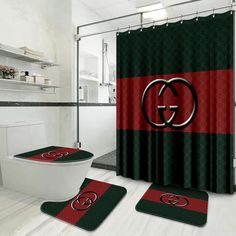 a bathroom with two rugs and a shower curtain in the shape of a gucci logo