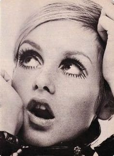 a woman with fake eyelashes on her face posing for a magazine advertiser's photo