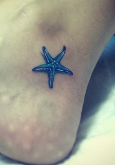 a small blue starfish tattoo on the foot