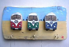 three wooden bus magnets mounted to the side of a wall