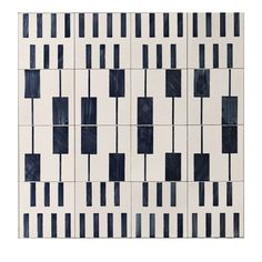 a white and blue tile with black squares on it