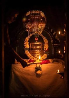 a candle is lit in front of a shrine