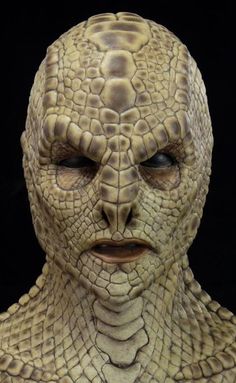 a close up of a person's face with an alligator skin pattern on it