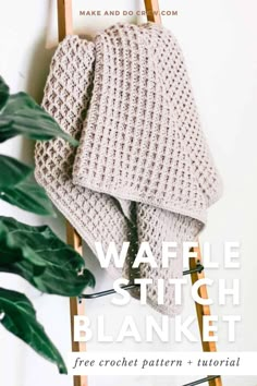 a crocheted blanket sitting on top of a ladder next to a potted plant