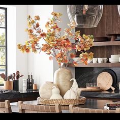 a vase with flowers in it sitting on top of a table next to some chairs