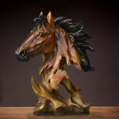 a statue of a horse is shown on a wooden table with a black and brown background