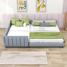 a large bed sitting on top of a hard wood floor next to a white rug