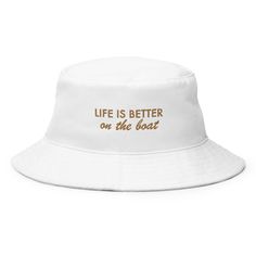 "The \"Life's Better On The Boat Bucket Hat\" is an essential in your closet! Combine practicality, comfort, and fashion in one. Keep the sun out of your eyes with this 100% cotton twill bucket hat. Cotton fabric and sewn eyelets are sure to help you stay cool during any activity, be it a stroll in the park or an intense game of sports. Details: * 100% cotton twill * 3 ¾″ (7.6 cm) crown * 2 ¼″ (5.1 cm) brim * One size fits most * Sewn eyelets for breathability *If you would like to change the co Bucket Hat Beach, Beach Bucket Hat, Beach Bucket, Embroidered Hat, Summer Hat, Embroidered Hats, The Boat, Beach Vibe, Custom Hats