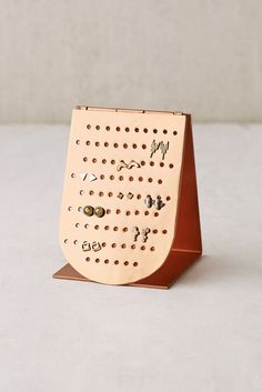 a wooden peg board with holes on the front and sides that say i love you