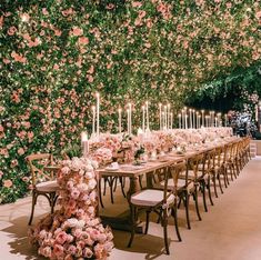 a long table is set with flowers and candles