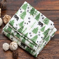 four pieces of fabric with bear and pine trees on them, next to some mushrooms