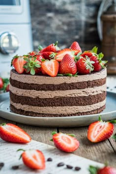 there is a chocolate cake with strawberries on top