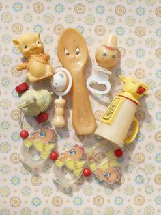 there are many different toys on the table together, such as toothbrushes and spoons