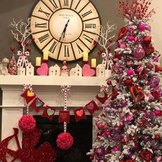 a decorated christmas tree in front of a clock