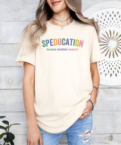 a woman standing in front of a wall wearing a t - shirt with the words, specducation on it