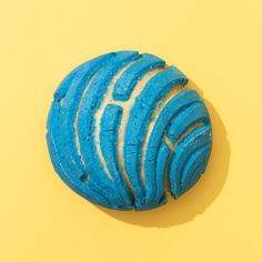 a blue doughnut sitting on top of a yellow surface