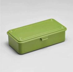 a green rectangular container with lid on a white surface and no background, it appears to be empty