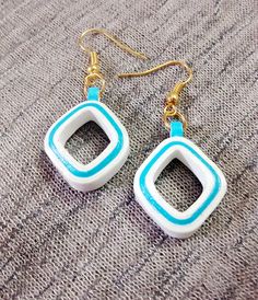 two square shaped earrings with blue and white accents