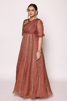 Chocolate brown three fourth puffed sleeves floor length panelled dress with front drape, 3D floral applique on shoulder and fully embellished pannels with scattered effect using dull gold diamond shaped rexin, pipes and beads embellishments. - Aza Fashions Festive Dresses With Gathered Sleeves, Fitted Dress With Gathered Sleeves For Festive Occasions, Fitted Dresses With Gathered Sleeves For Festivities, Festive Wedding Dress With Gathered Sleeves, Panelled Dress, Maxi Dress For Women, Panel Dress, Floral Applique, Diamond Shaped