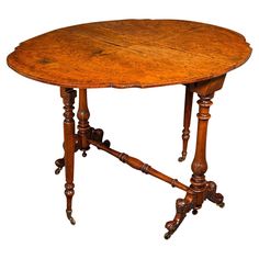 an old wooden table with two turned legs