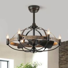 a chandelier with lights hanging from it's center and wood accents on the bottom